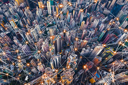 A futuristic scene captured from above, showcasing a smart city where buildings are interconnected